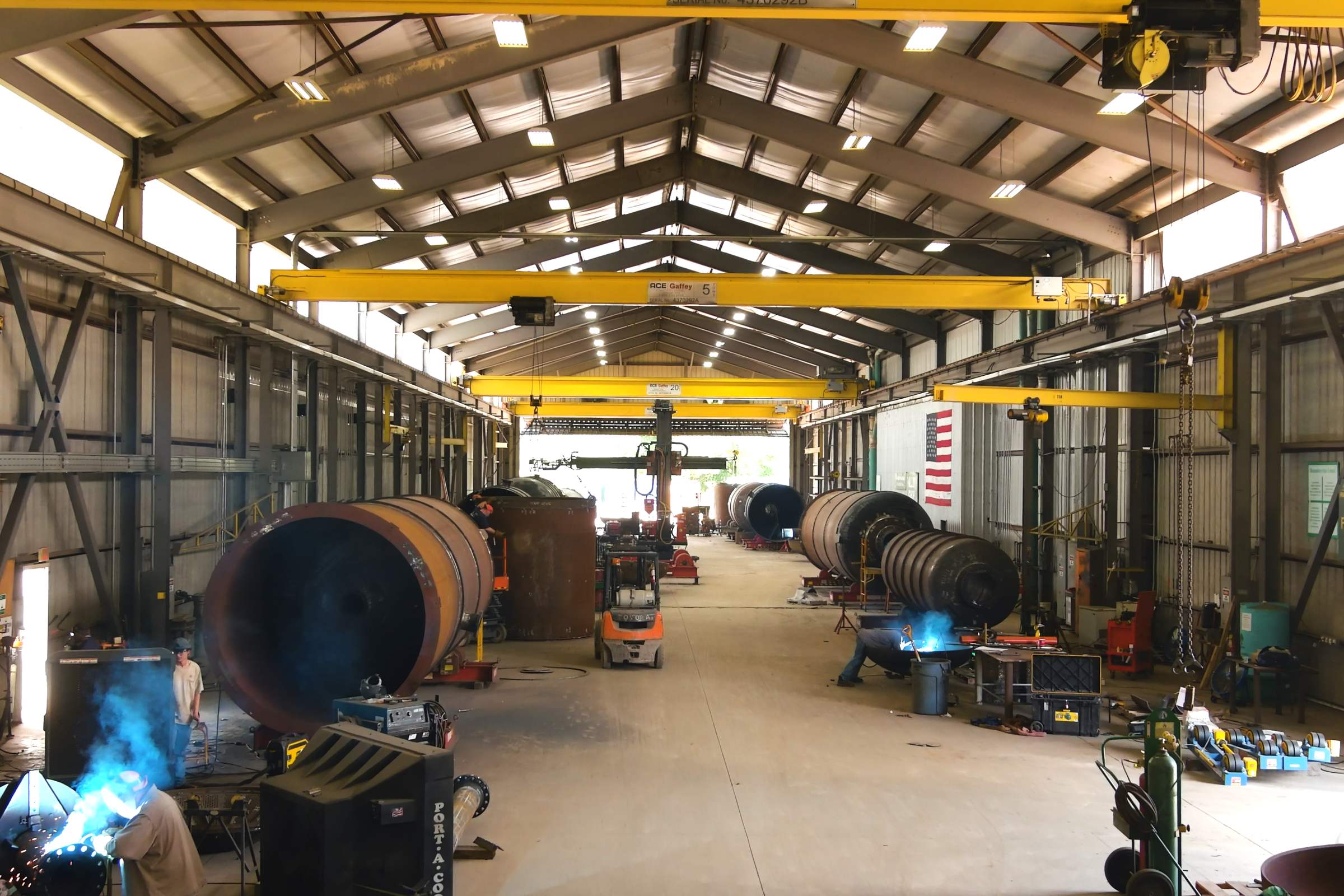 Welder fabricating a pressure vessel inside PALA's Louisiana fabrication shop